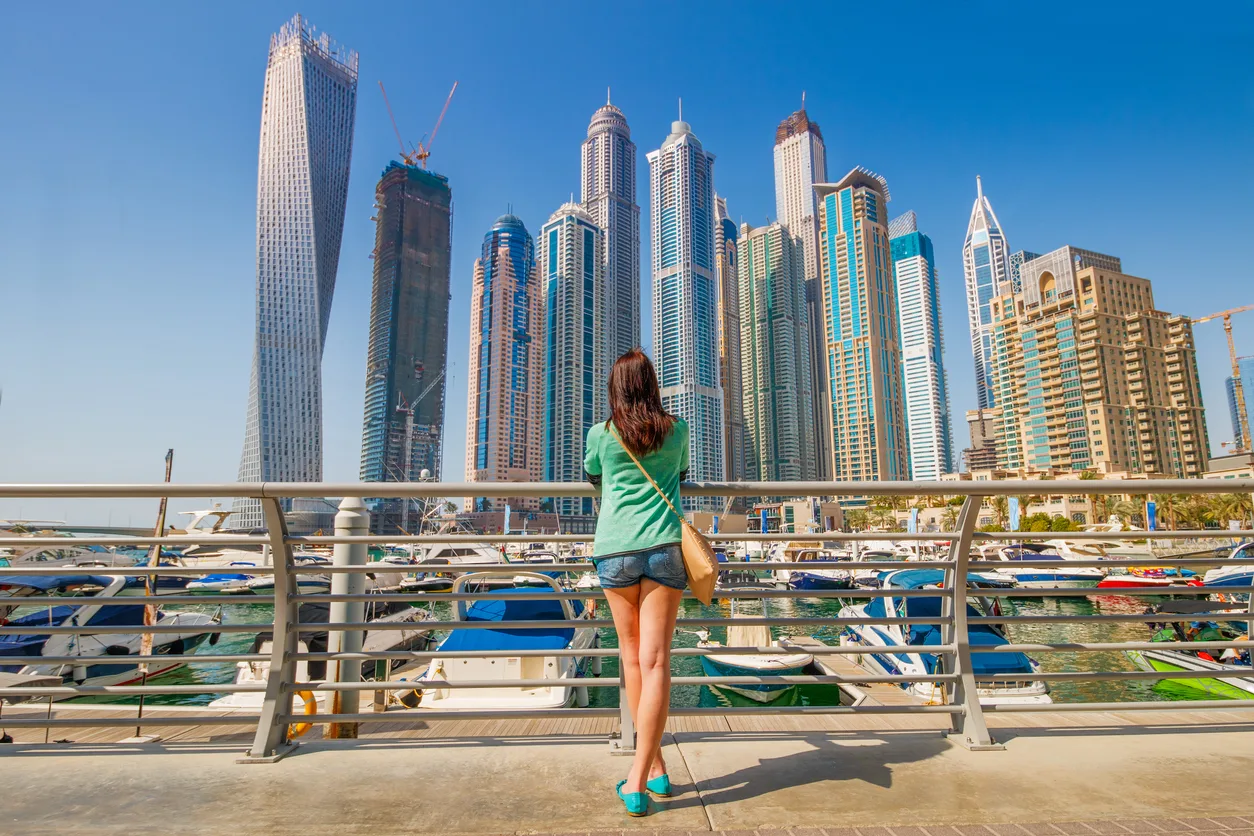 Skyscrapers rising above the yacht berths of Dubai Marina on a clear day