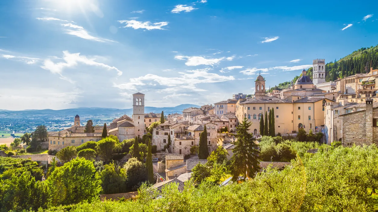 The hill town of Assisi in Umbria, with its basilica rising above green countryside