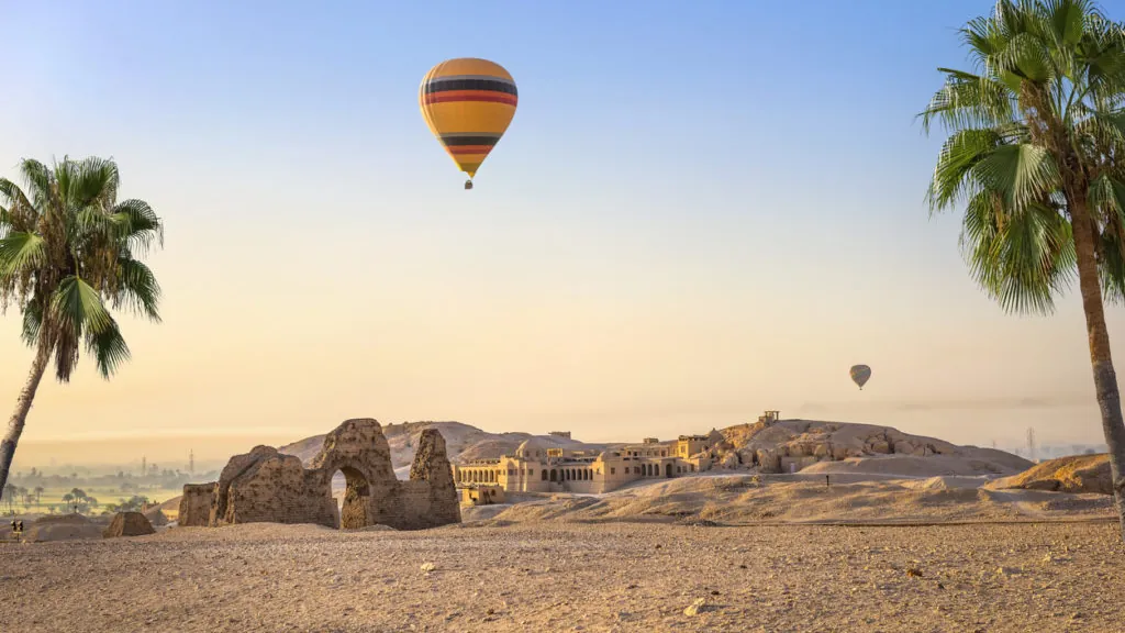 A hot-air balloon drifting over the ruins near the Temple of Hatshepsut on Luxor’s West Bank