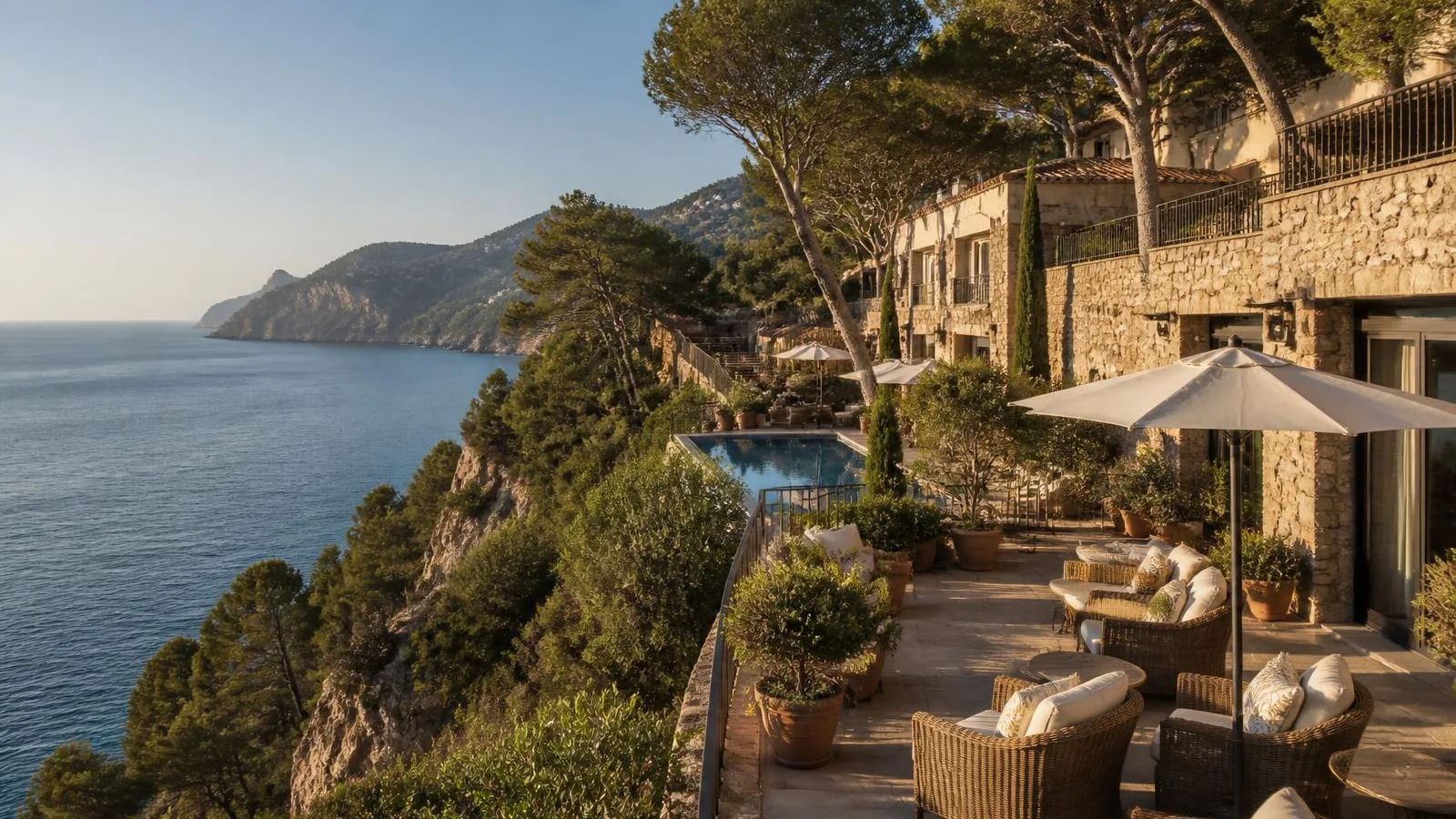 Cliffside Mallorcan resort terrace overlooking the Mediterranean at golden hour