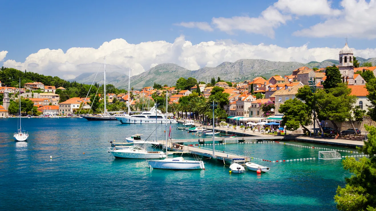 Boats moored in the clear turquoise harbour of Cavtat on the Dalmatian coast near Dubrovnik